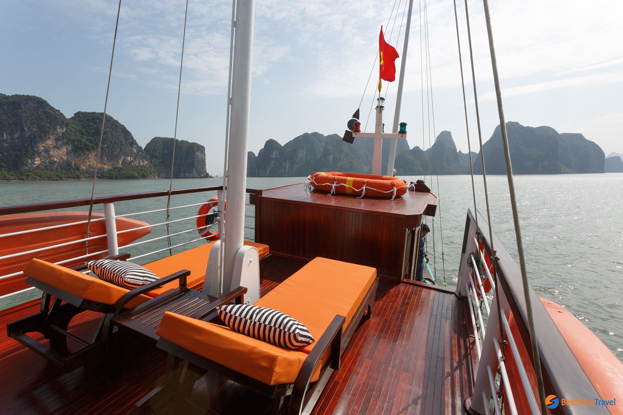 Admire the stunning beauty of Halong Bay on sunbeds
