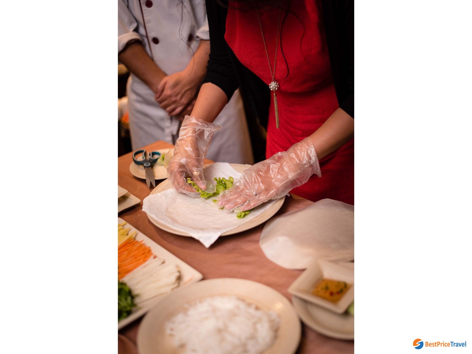 A guest try to make a spring roll in Cooking Class