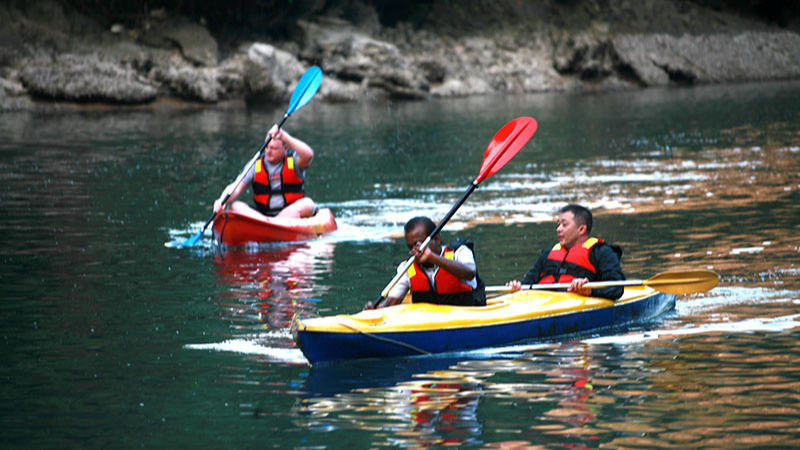 Kayaking on the tranquil water of Halong Bay