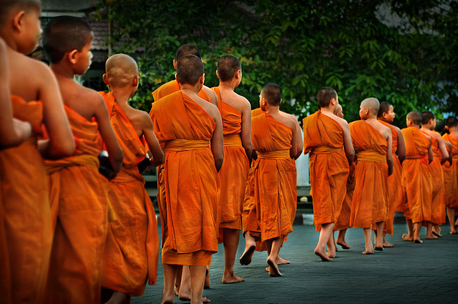 Buddhist monks line up on the streets in Luang Prabang