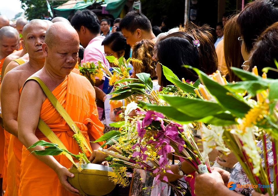 Offering food to the monks in Khao Phan Sa festival