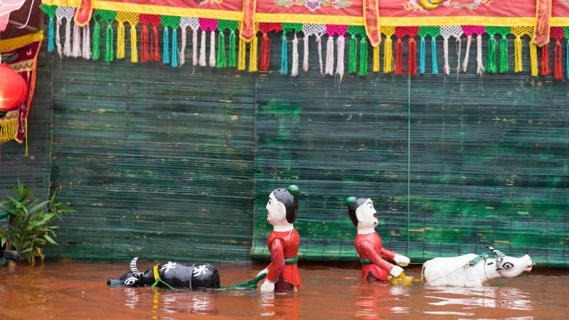 Farming' Group Of Scenes In A Water Puppet Show