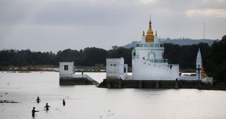 Fishermen Cast Their Lines Near A Pagoda On Taungthaman Lake In The City Of Mandalay.