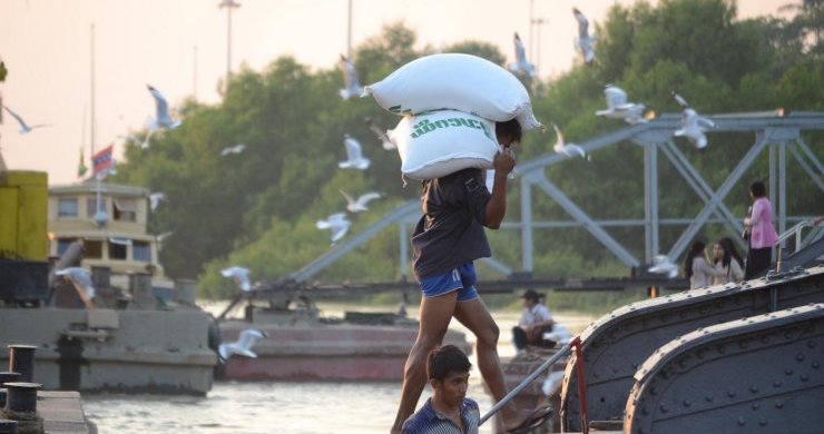A Labourer Unloading Rice From A Ship At Botahtaung Jetty