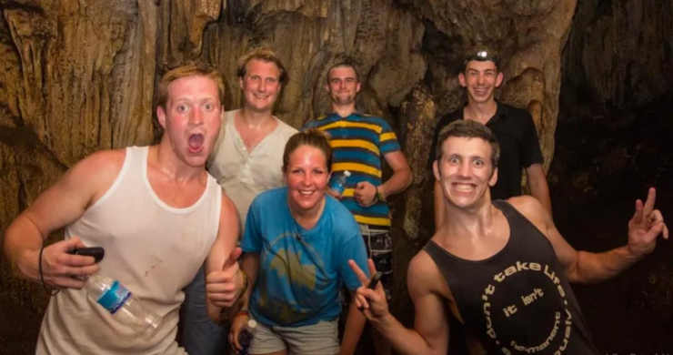 Tourists Exploring The Cave By A Large Group