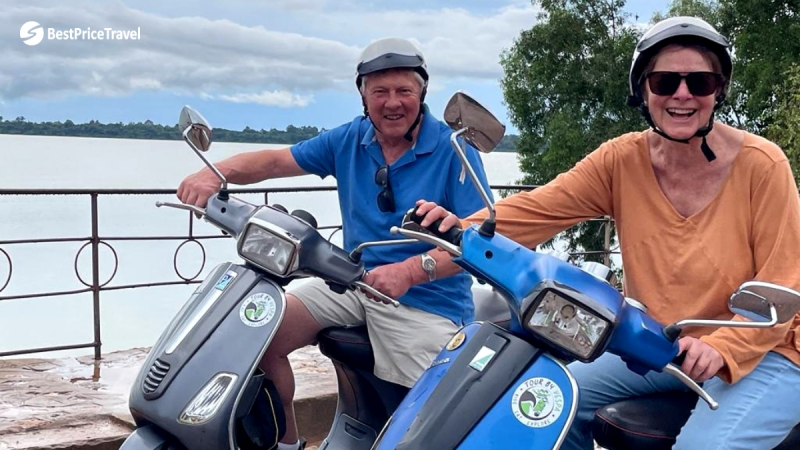 A Couple Is Cheerful While Driving Vespa Motorbikes For The First Time