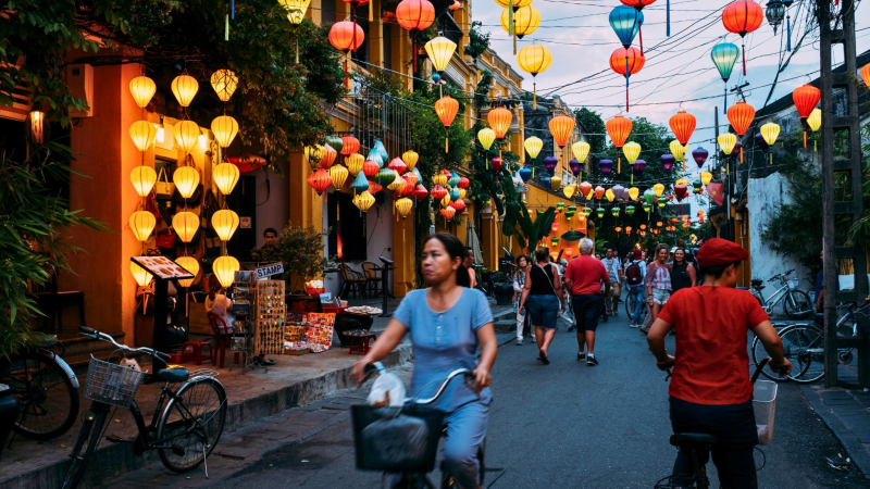 Immersed In The Lively Street Scene Of Hoi An With Bright Lanterns