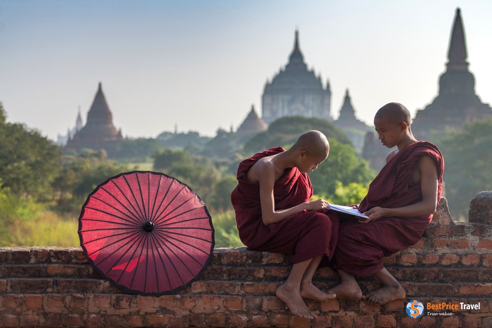 Young Monks With The Temple Strewn Skyline Of Bagan In The Background.