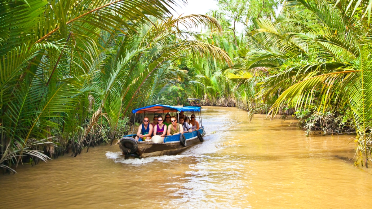 Drive The Small Sampan Boat Through The Small Canals In Mekong