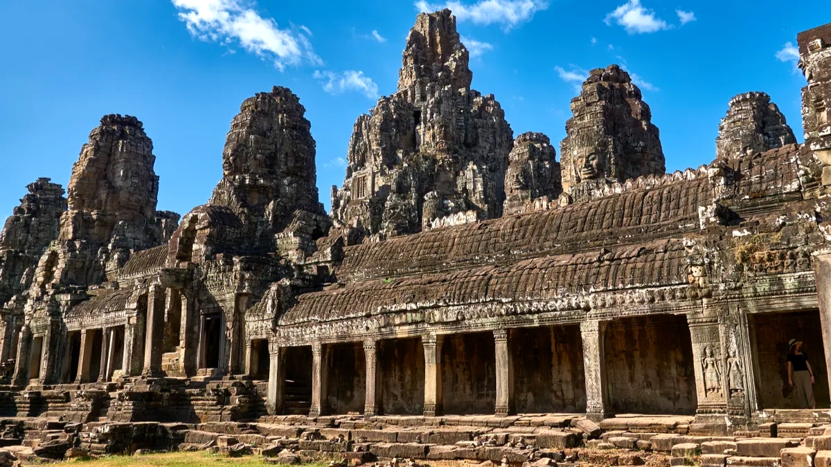 Gaze In Awe At The Famous And Impressive Colossal Human Faces Carved In Stone At Bayon Temple